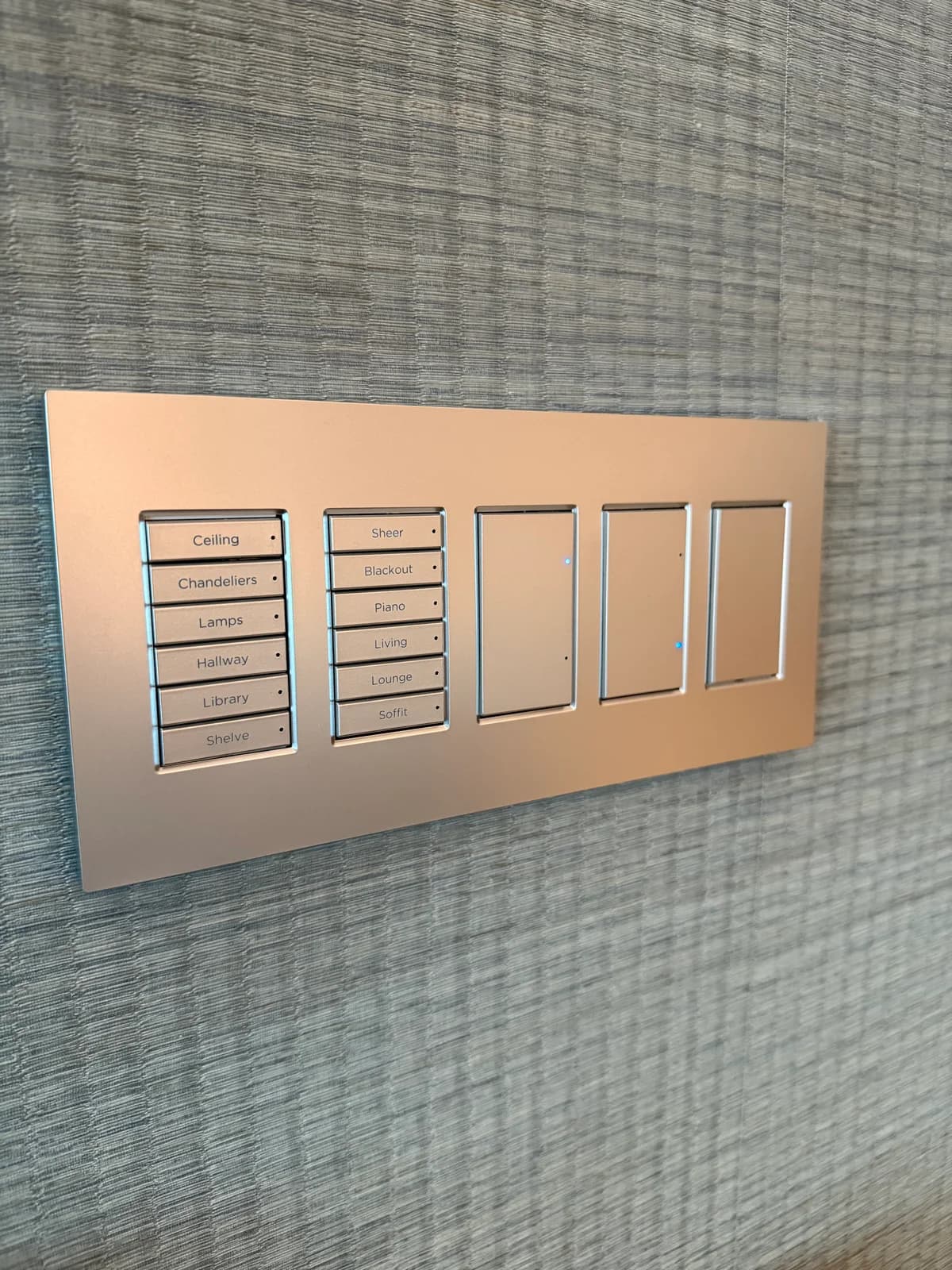 Front view of custom engraved scene control keypad with rose-gold finish and labels for ceiling, chandeliers, lamps, hallway, and library