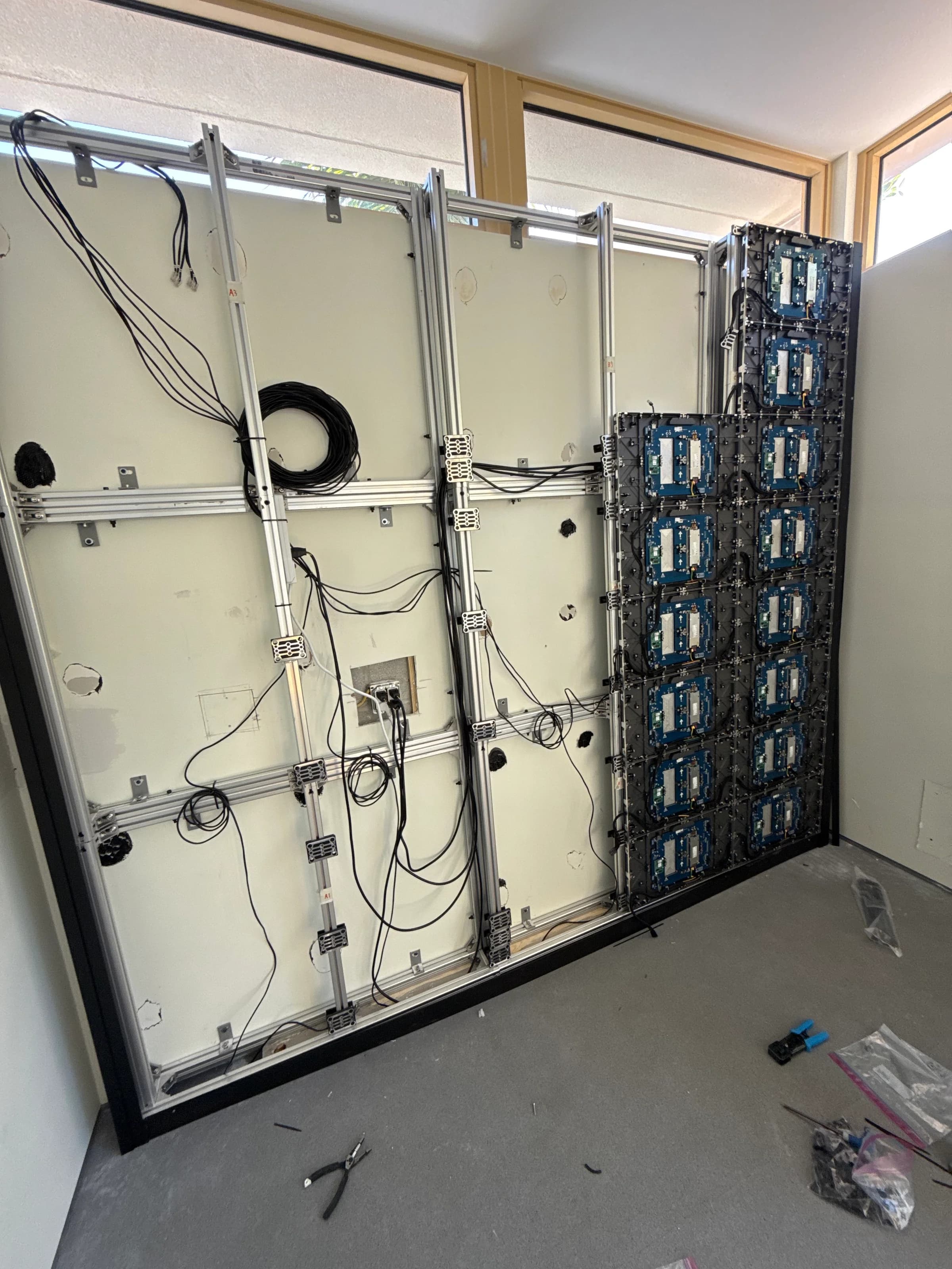 Custom LED video wall partially populated during installation with frame and cabling visible