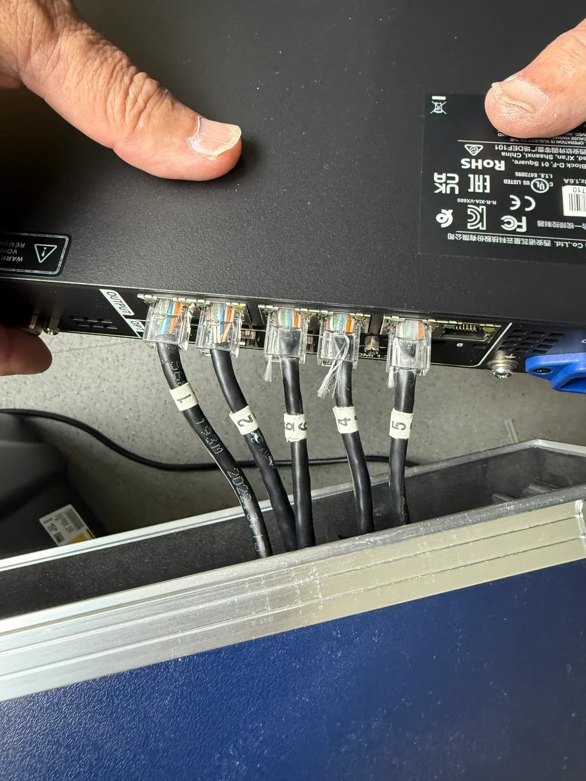 Numbered and labeled CAT.6 ethernet cables plugged into a network device